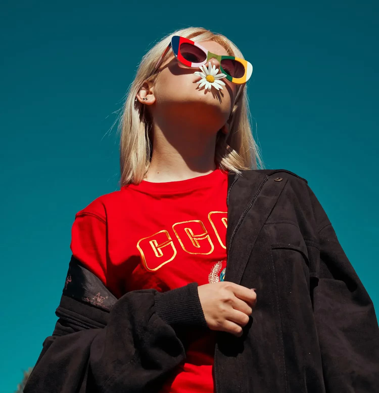 Model in sunglasses and a red top
